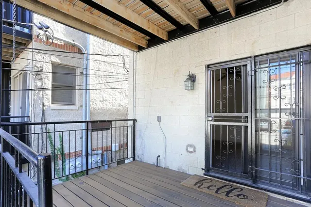 a view of a balcony with wooden floor