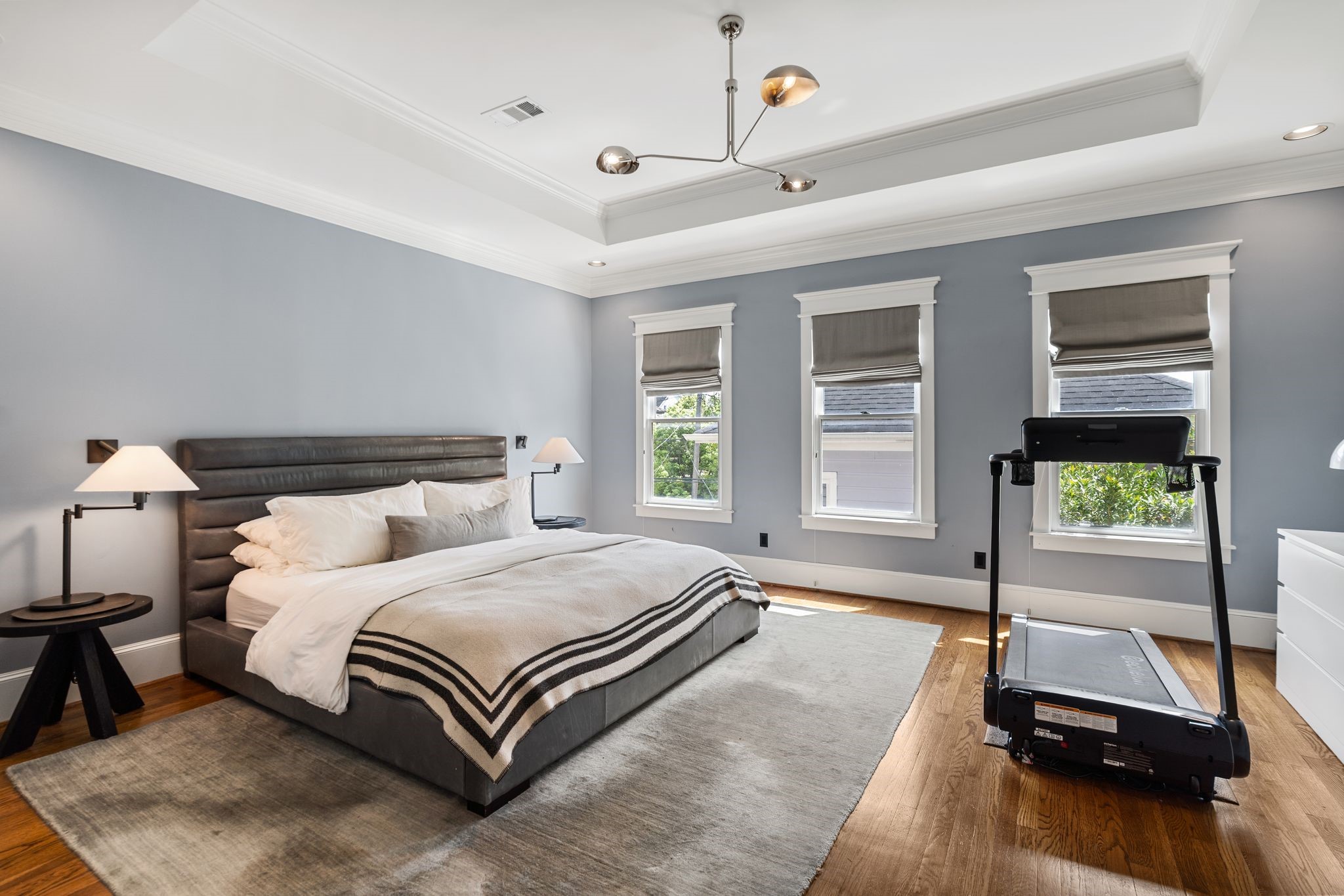 908 East 26th Street Houston, TX 77009 - Photo 17 of 30 The primary suite offers updated lighting, custom shades, and hardwood floors.