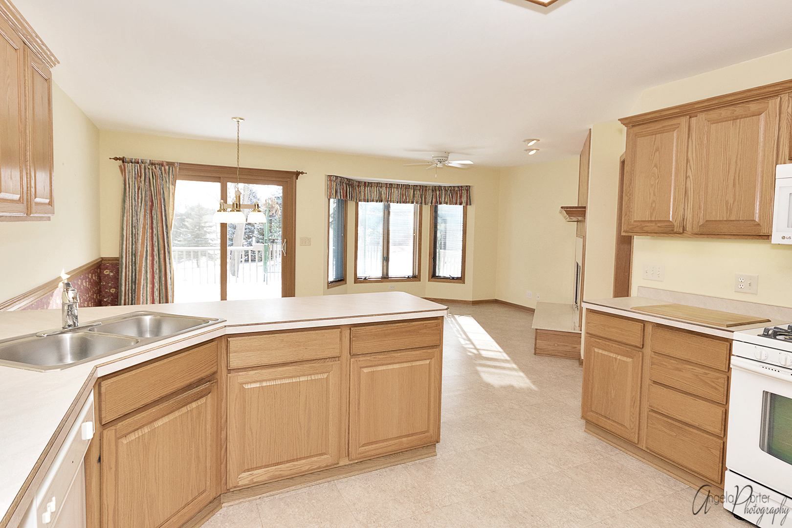 1409 Elm Street Spring Grove, IL 60081 - Photo 7 of 28 a large kitchen with cabinets and a sink