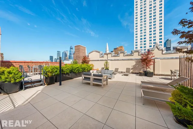 a bathroom with a granite countertop sink a toilet and shower