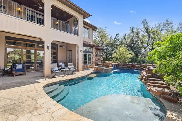 a view of a house with backyard porch and sitting area