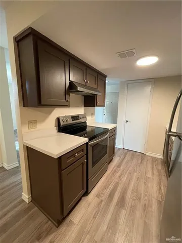 a kitchen with a stove and a microwave