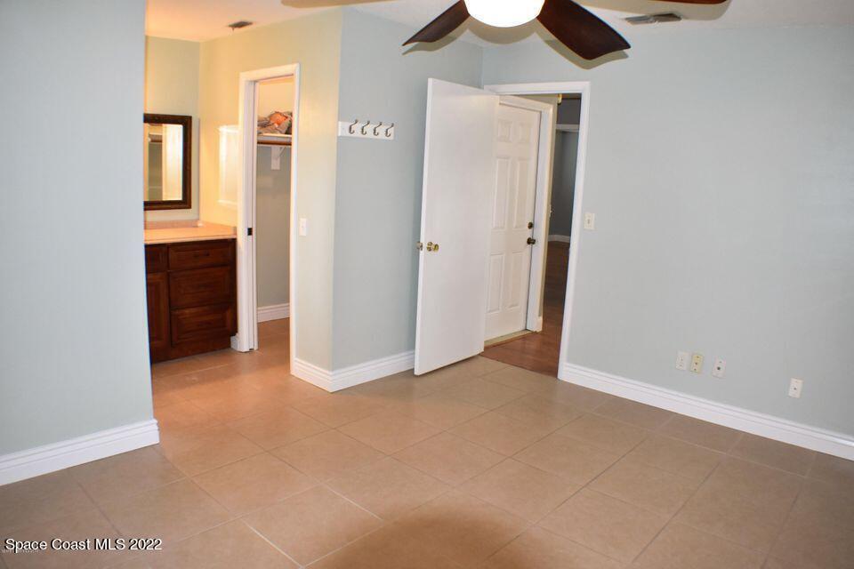 3335 Jay Tee Drive Melbourne, FL 32901 - Photo 12 of 37 an empty room with chandelier fan and windows