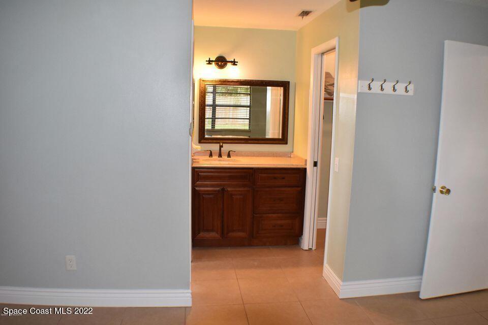 3335 Jay Tee Drive Melbourne, FL 32901 - Photo 13 of 37 a bathroom with a sink and a mirror