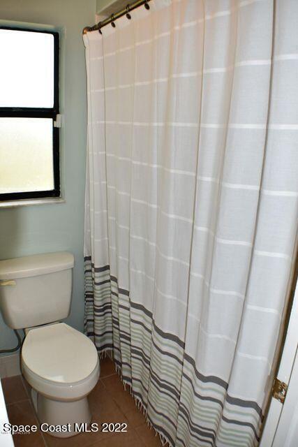 3335 Jay Tee Drive Melbourne, FL 32901 - Photo 15 of 37 a bathroom with a toilet and a shower