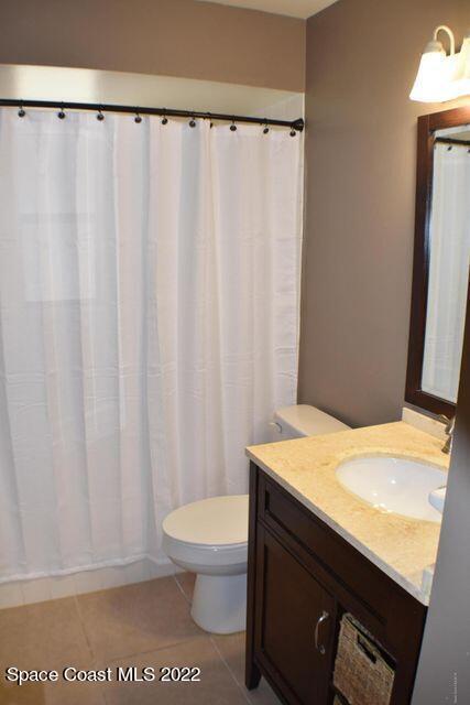 3335 Jay Tee Drive Melbourne, FL 32901 - Photo 20 of 37 a bathroom with a granite countertop sink and a toilet
