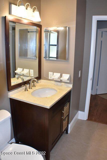 3335 Jay Tee Drive Melbourne, FL 32901 - Photo 22 of 37 a bathroom with a sink vanity and mirror