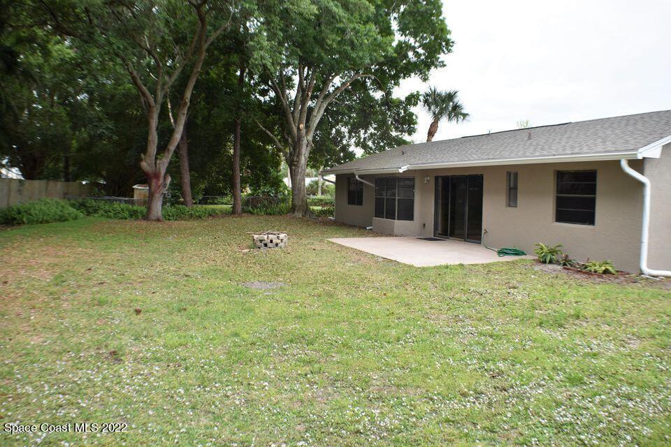 3335 Jay Tee Drive Melbourne, FL 32901 - Photo 26 of 37 a backyard of a house with yard and outdoor seating