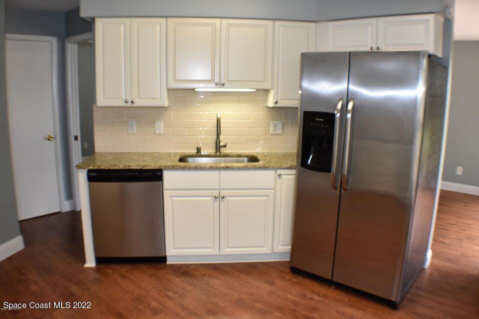 3335 Jay Tee Drive Melbourne, FL 32901 - Photo 5 of 37 a kitchen with a refrigerator sink and cabinets