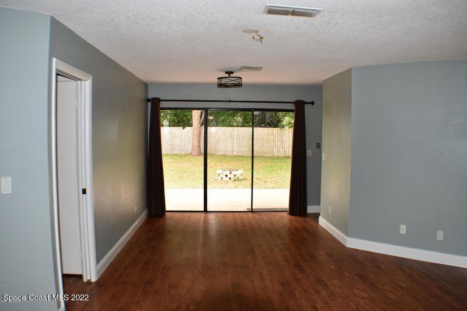 3335 Jay Tee Drive Melbourne, FL 32901 - Photo 8 of 37 wooden floor in an empty room with a window