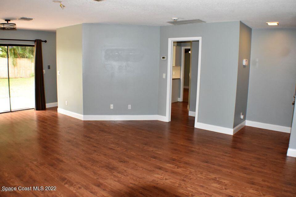 3335 Jay Tee Drive Melbourne, FL 32901 - Photo 9 of 37 an empty room with wooden floor and windows