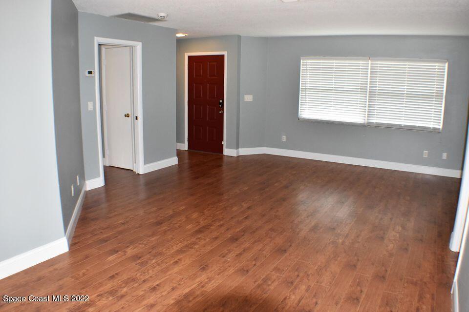 3335 Jay Tee Drive Melbourne, FL 32901 - Photo 10 of 37 an empty room with wooden floor and windows