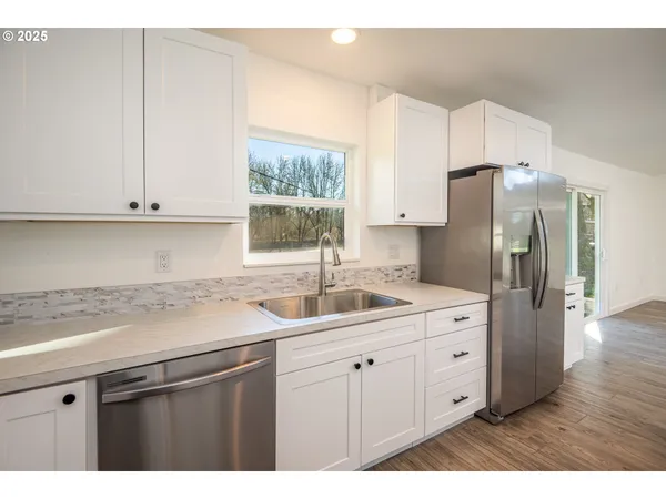a kitchen with appliances a sink and a stove