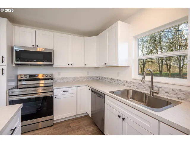 a kitchen with a wooden floor and cabinets