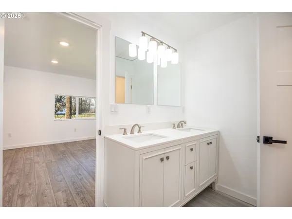 a bathroom with a sink a mirror and a shower