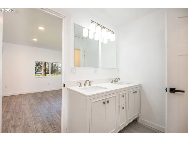 a bathroom with a sink a mirror and a shower