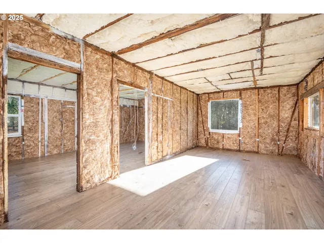 a view of backyard with potted plants and wooden fence