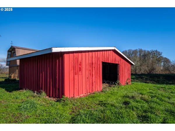 a view of a back yard with a wooden fence
