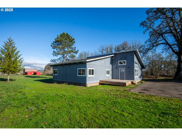 a view of an entryway with wooden floor and a living room