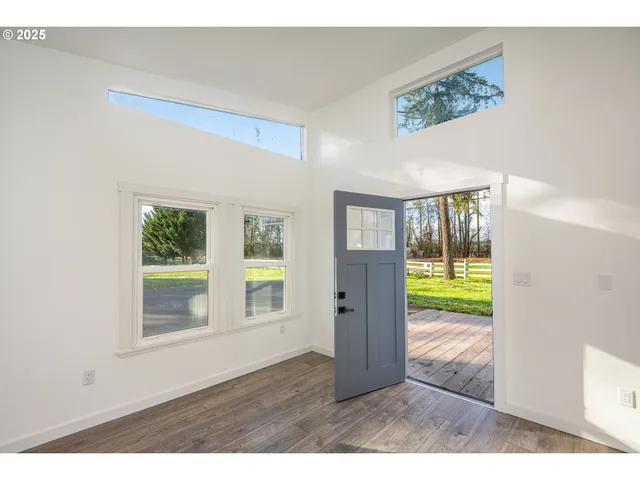a open kitchen with cabinets and wooden floor