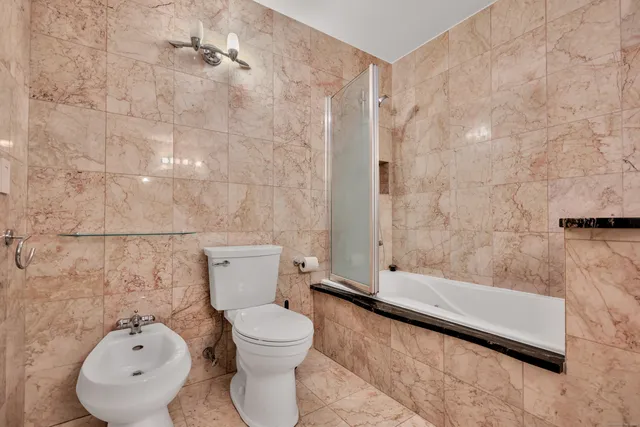 a bathroom with a toilet and a shower