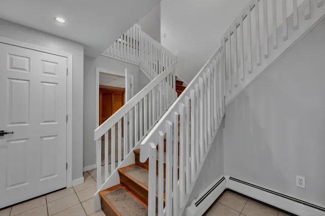 a view of entryway with wooden floor and stairs