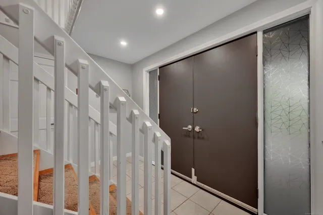 a bathroom with a shower and a glass door