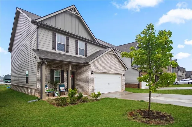 a front view of a house with a yard and garage