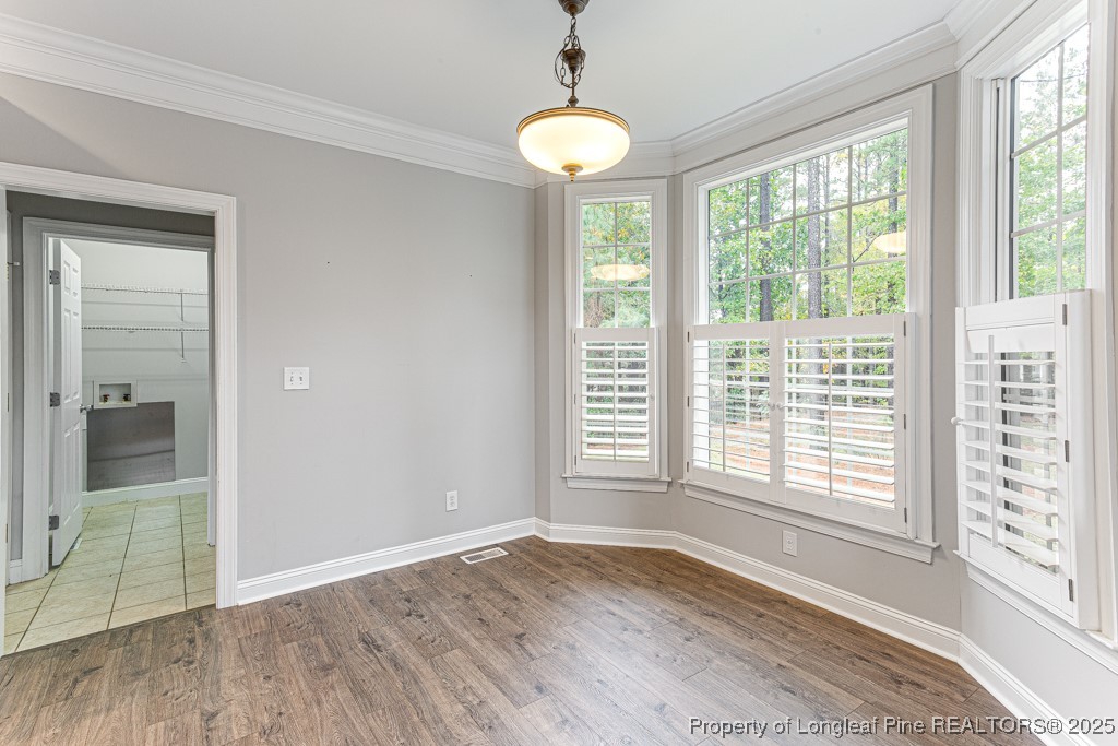 367 Falling Water Road Spring Lake, NC 28390 - Photo 14 of 41 a view of an empty room with wooden floor and a window