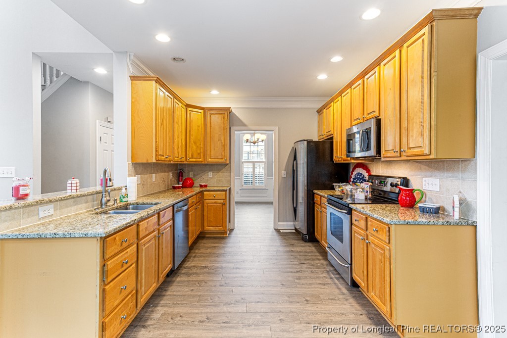 367 Falling Water Road Spring Lake, NC 28390 - Photo 16 of 41 a kitchen with stainless steel appliances granite countertop sink stove refrigerator and cabinets