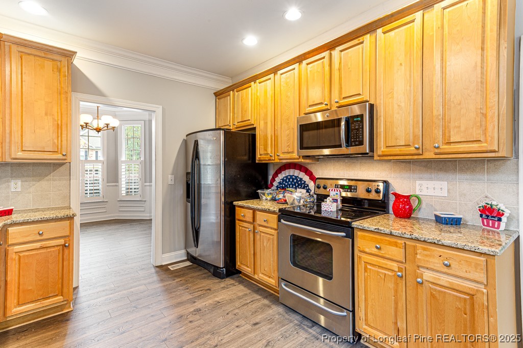 367 Falling Water Road Spring Lake, NC 28390 - Photo 18 of 41 a kitchen with stainless steel appliances granite countertop a stove a sink dishwasher a refrigerator and a microwave
