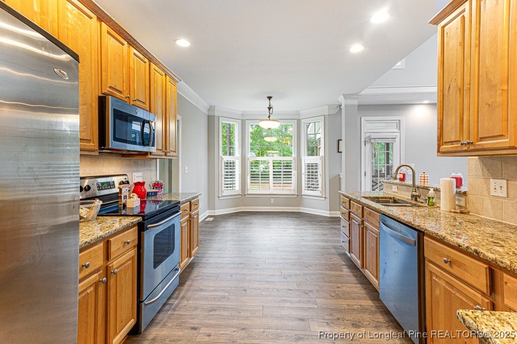 367 Falling Water Road Spring Lake, NC 28390 - Photo 19 of 41 a kitchen with stainless steel appliances kitchen island granite countertop a stove sink and cabinets