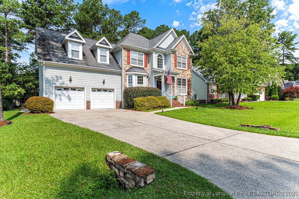 367 Falling Water Road Spring Lake, NC 28390 - Photo 2 of 41 a front view of a house with a yard and garage