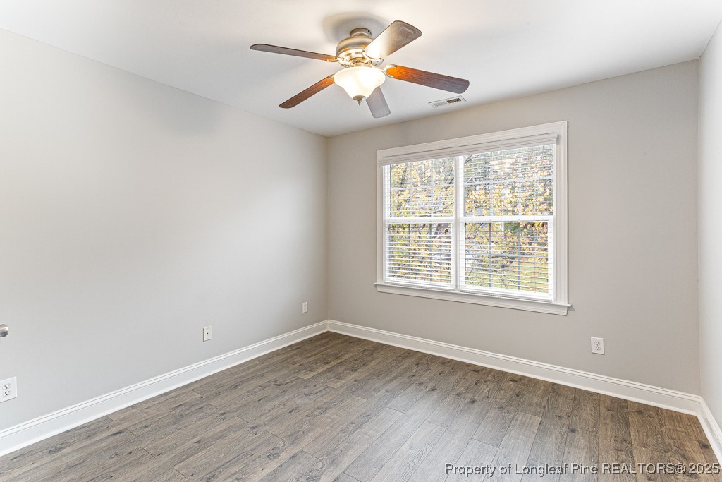 367 Falling Water Road Spring Lake, NC 28390 - Photo 23 of 41 an empty room with wooden floor and windows