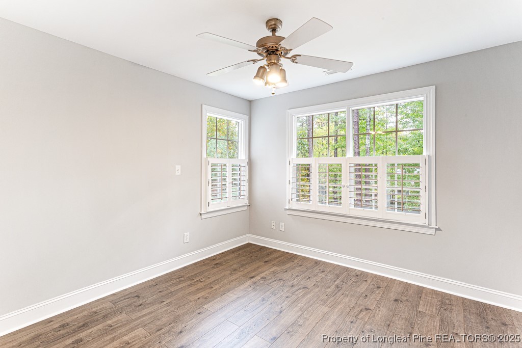 367 Falling Water Road Spring Lake, NC 28390 - Photo 26 of 41 an empty room with wooden floor and windows
