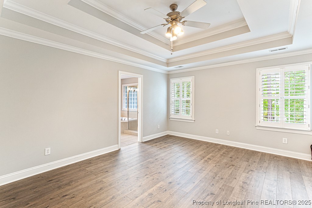 367 Falling Water Road Spring Lake, NC 28390 - Photo 28 of 41 an empty room with wooden floor fan and windows
