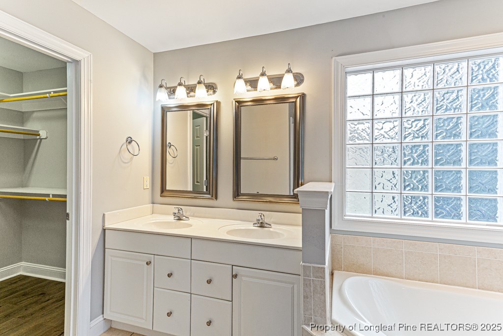 367 Falling Water Road Spring Lake, NC 28390 - Photo 30 of 41 a bathroom with a double vanity sink and a bathtub