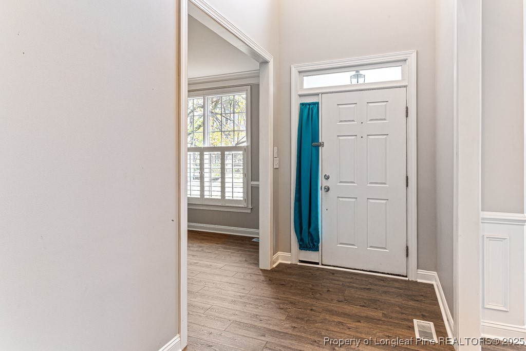 367 Falling Water Road Spring Lake, NC 28390 - Photo 3 of 41 an empty room with wooden floor closet and windows