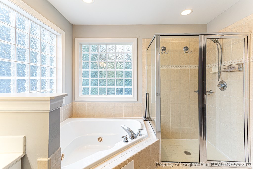 367 Falling Water Road Spring Lake, NC 28390 - Photo 31 of 41 a bathroom with a bathtub shower and a window