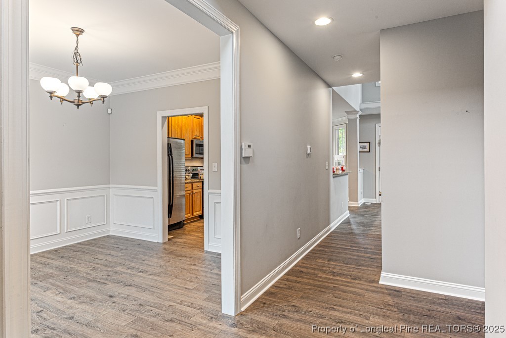 367 Falling Water Road Spring Lake, NC 28390 - Photo 4 of 41 a view of a hallway with wooden floor and chandelier