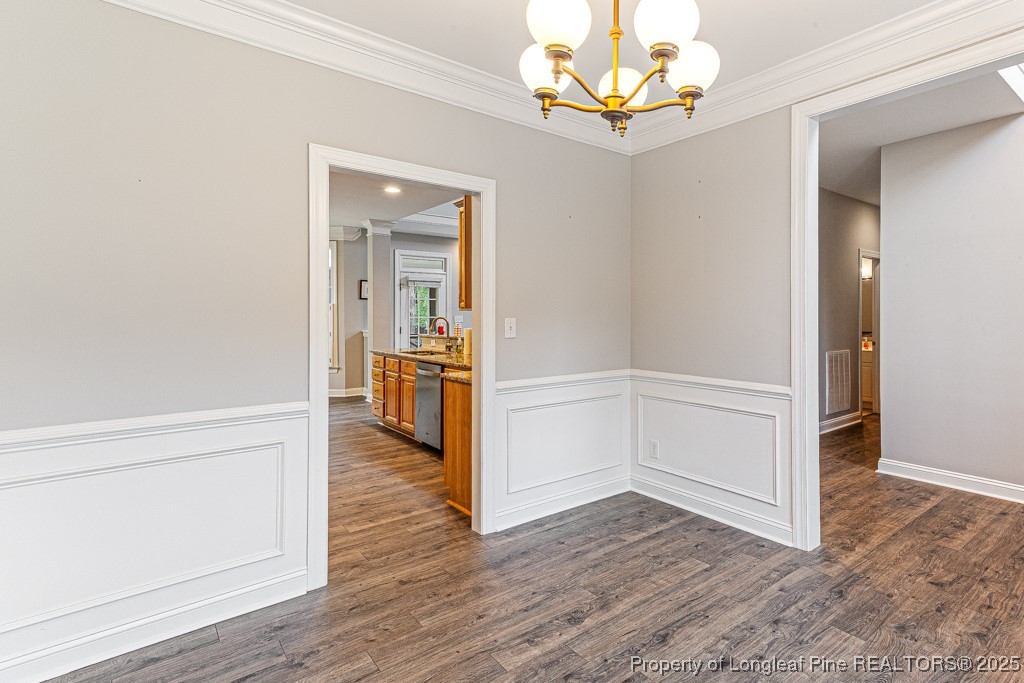 367 Falling Water Road Spring Lake, NC 28390 - Photo 8 of 41 wooden floor in an empty room with a chandelier