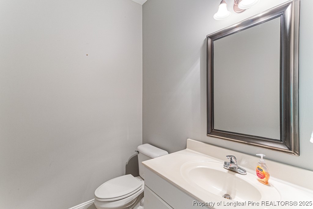 367 Falling Water Road Spring Lake, NC 28390 - Photo 9 of 41 a bathroom with a sink vanity mirror and toilet