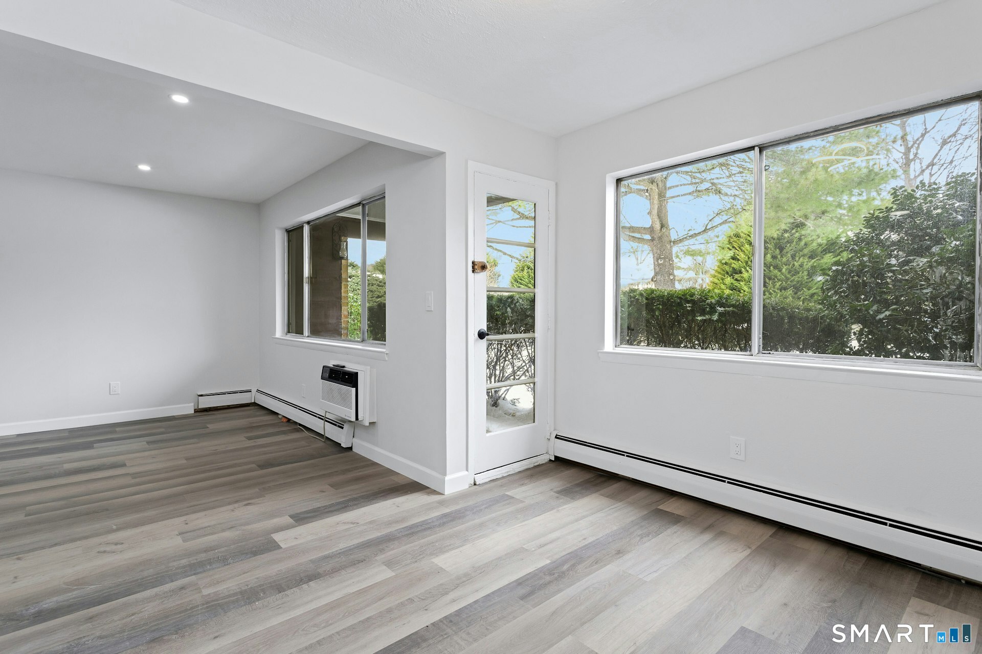 154 Cold Spring Road, Unit 18 Stamford, CT 06905 - Photo 15 of 28 a view of an empty room with wooden floor and a window