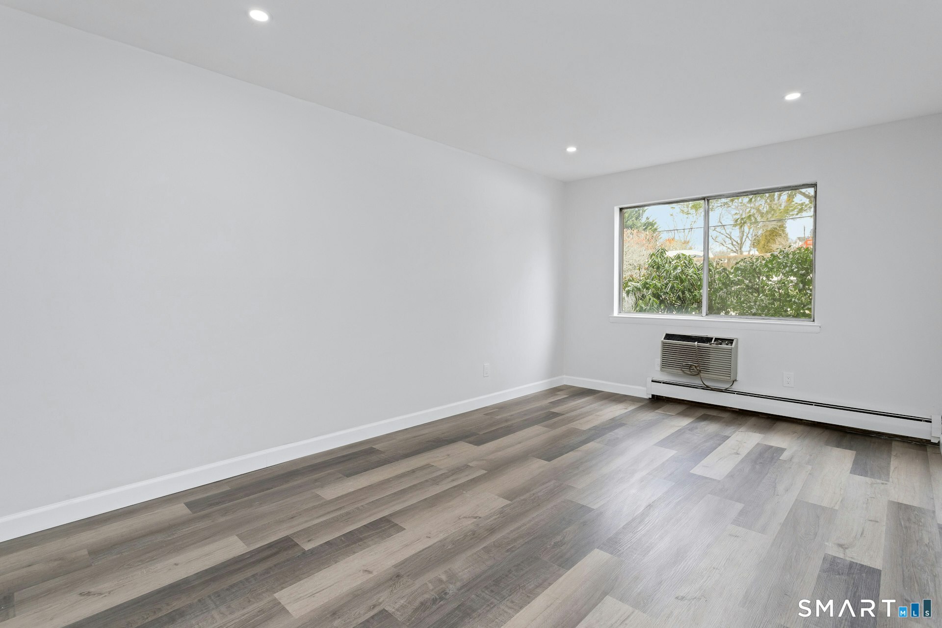 154 Cold Spring Road, Unit 18 Stamford, CT 06905 - Photo 19 of 28 wooden floor in an empty room with a window