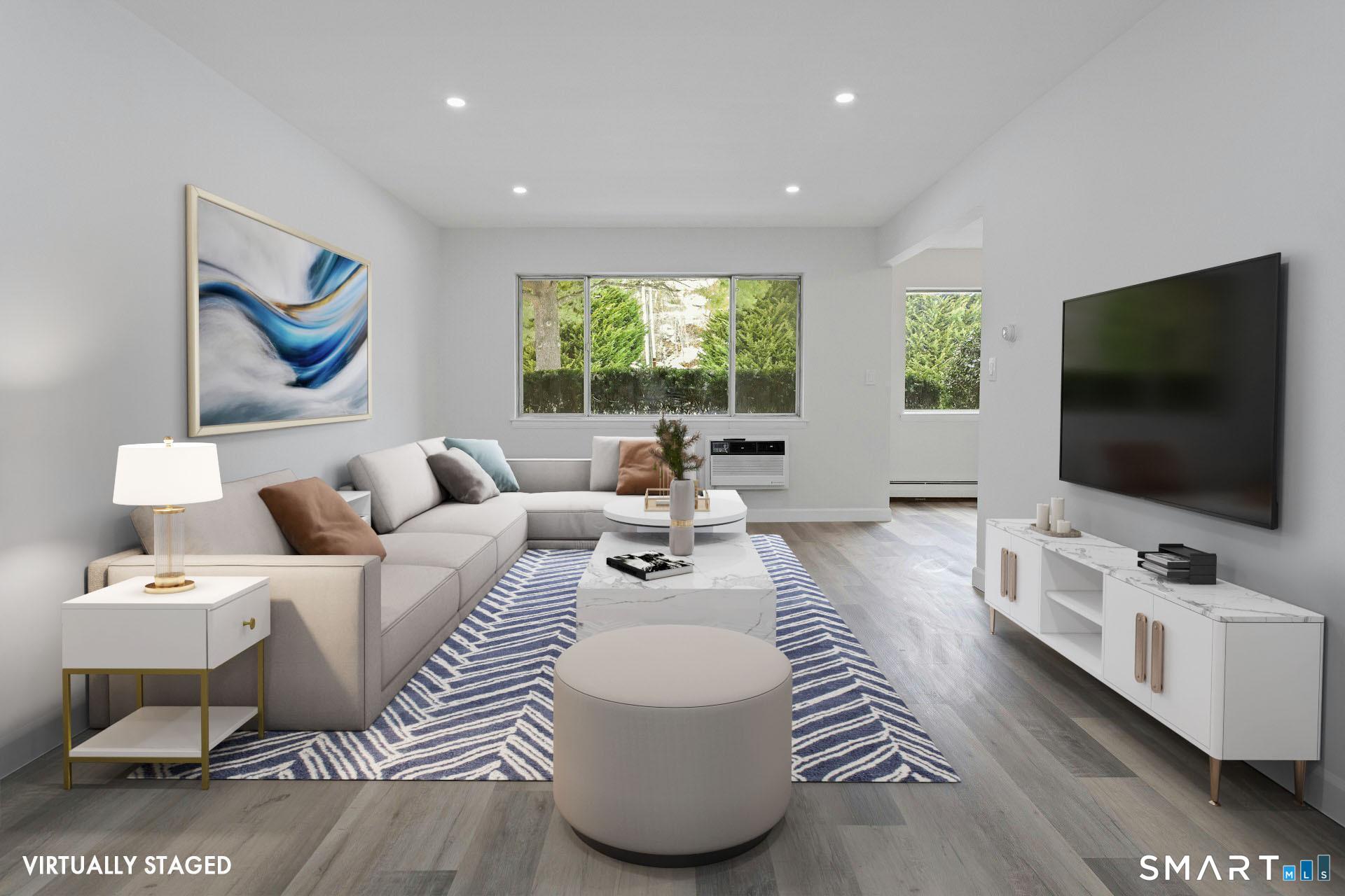 154 Cold Spring Road, Unit 18 Stamford, CT 06905 - Photo 5 of 28 a living room with furniture and a flat screen tv