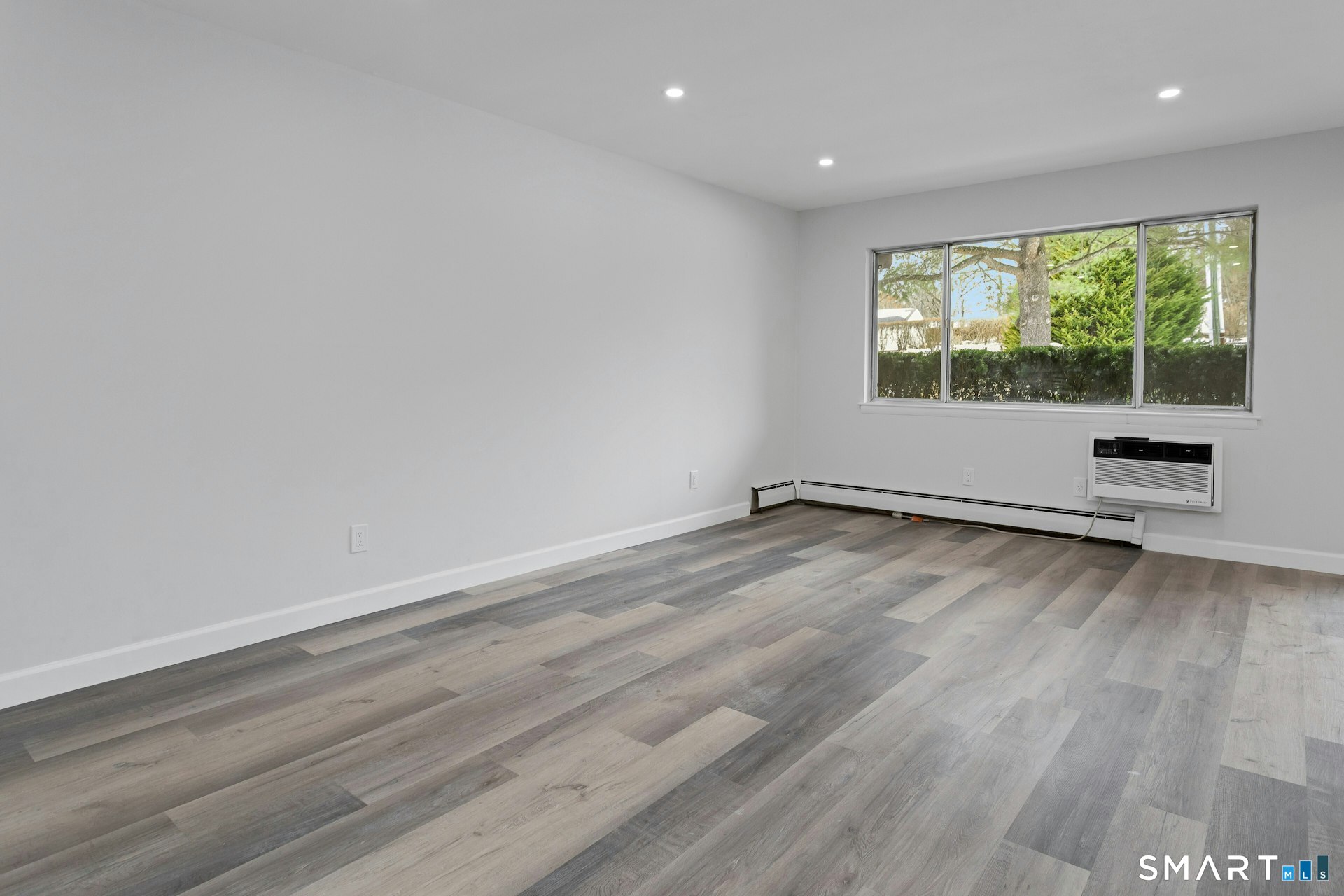 154 Cold Spring Road, Unit 18 Stamford, CT 06905 - Photo 9 of 28 a view of a room with wooden floor and a window