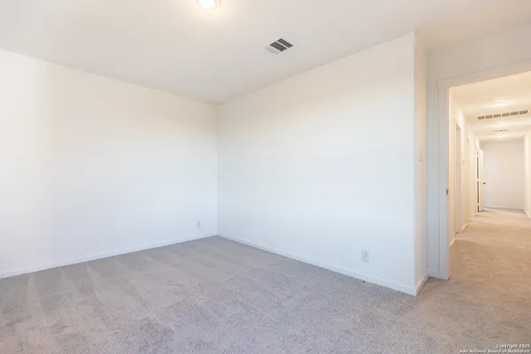 a view of an empty room and a window