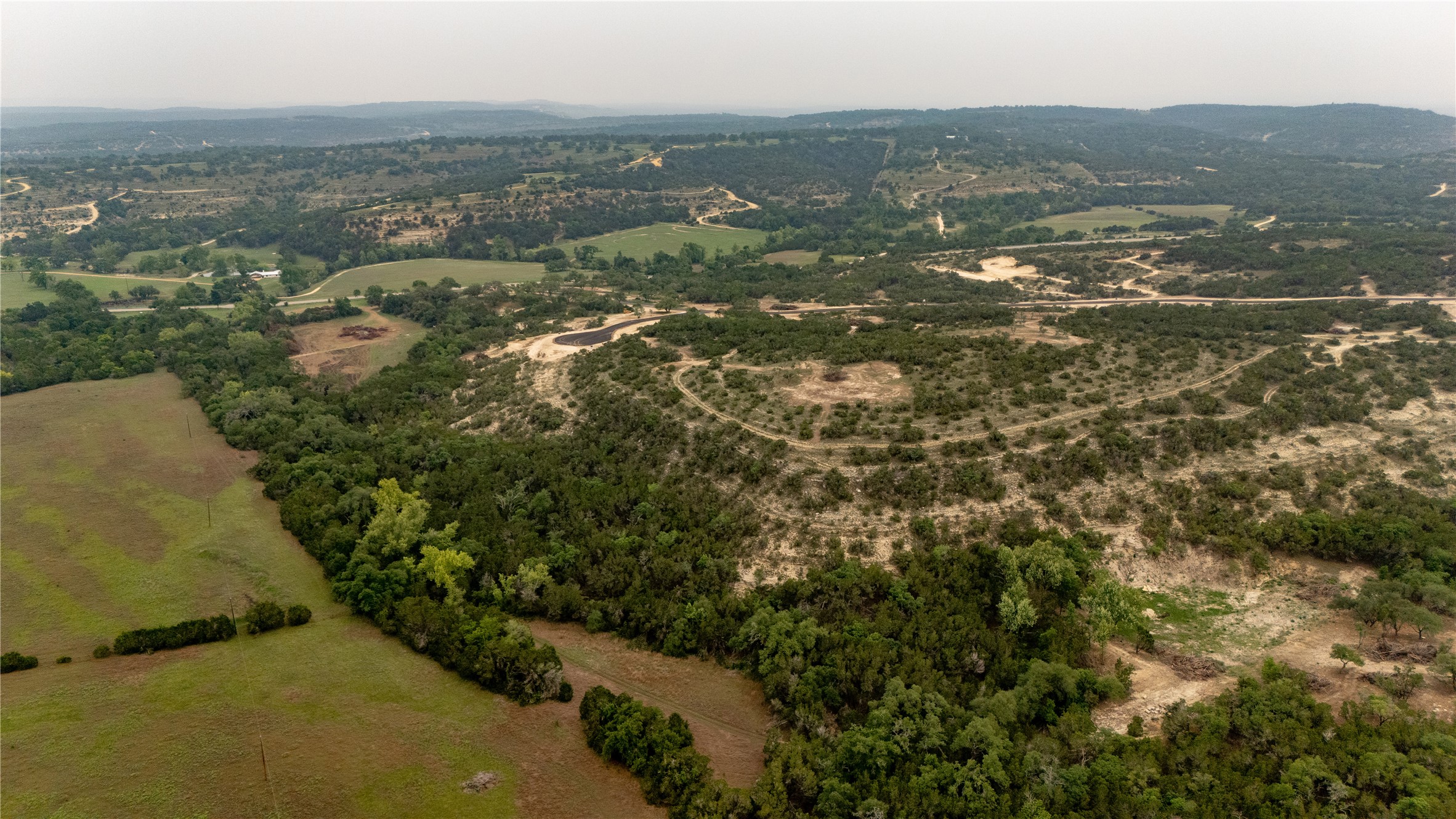 Lot 23 Ranch Road 165 Dripping Springs, TX 78620 - Photo 9 of 12 an aerial view of residential houses with outdoor space and trees