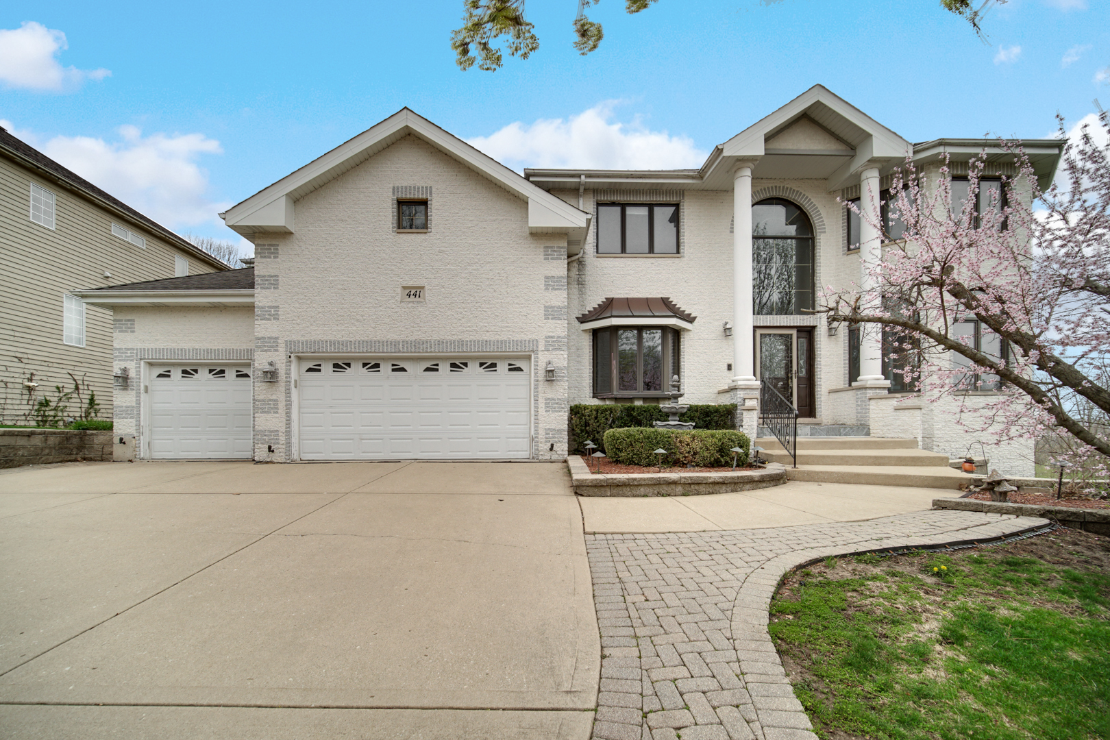 441 Delaware Circle Bolingbrook, IL 60440 - Photo 1 of 69 a view of a white house with large windows and a yard with plants