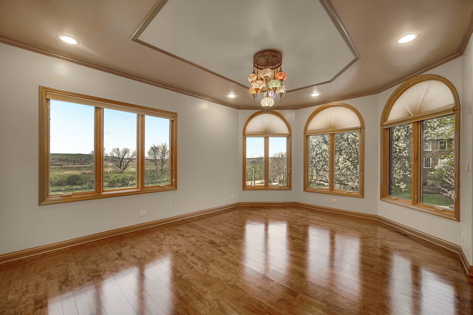 441 Delaware Circle Bolingbrook, IL 60440 - Photo 16 of 69 a view of an empty room with wooden floor and a window
